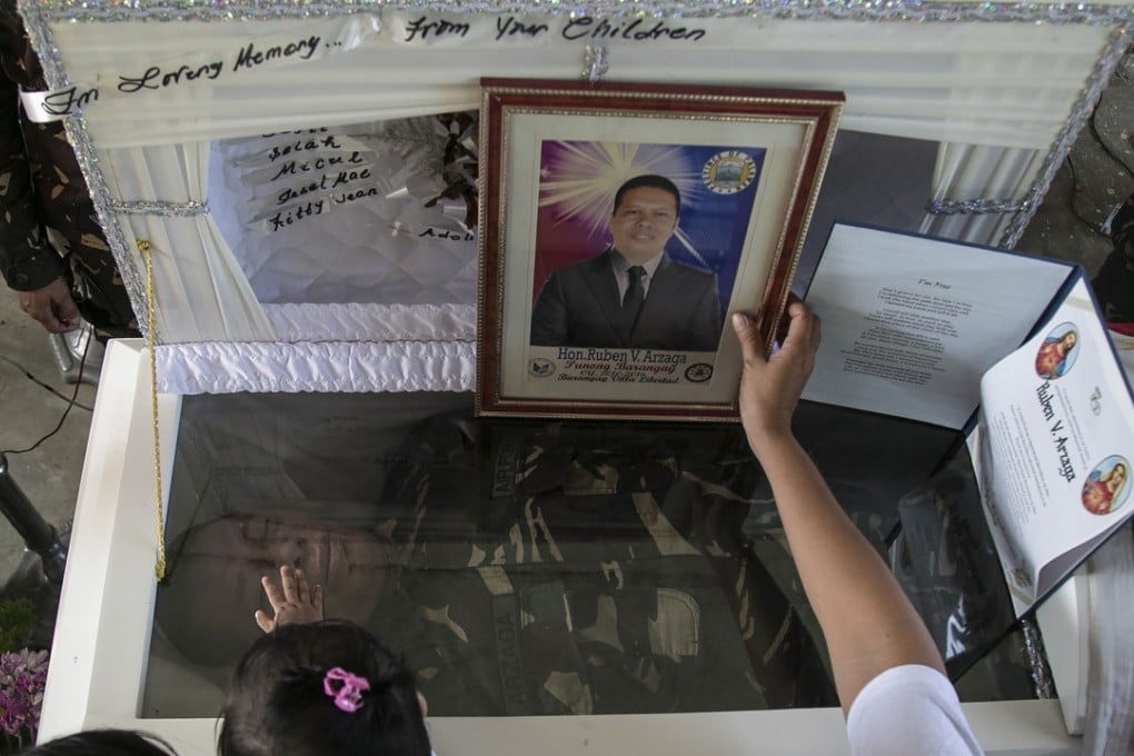 Mourners pay their respects to murdered environmental para-enforcer Ruben Arzaga. Photo: AFP