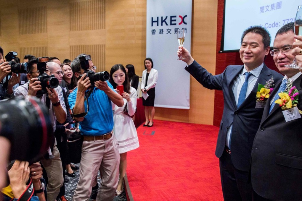 China Literature Limited co-chief executive officers Liang Xiaodong (left) and Wu Wenhui (right) at its IPO on November 8. But with the lack of any real blockbuster floats, especially hi-tech listings, in the city this year, there has been little to toast and Hong Kong now looks to have lost its top IPO global ranking, slipping to third behind New York and Shanghai. Photo: AFP