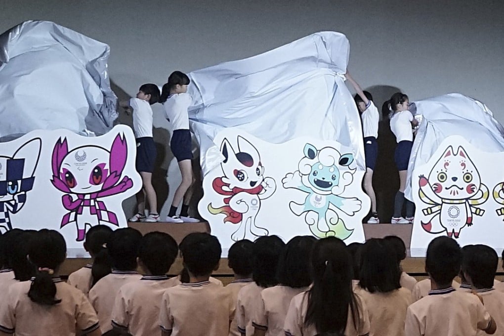 Pupils unveil the shortlisted three mascot design sets which each contain one mascot for the Tokyo 2020 Olympic Games and one for the Paralympic Games. Photo: AP