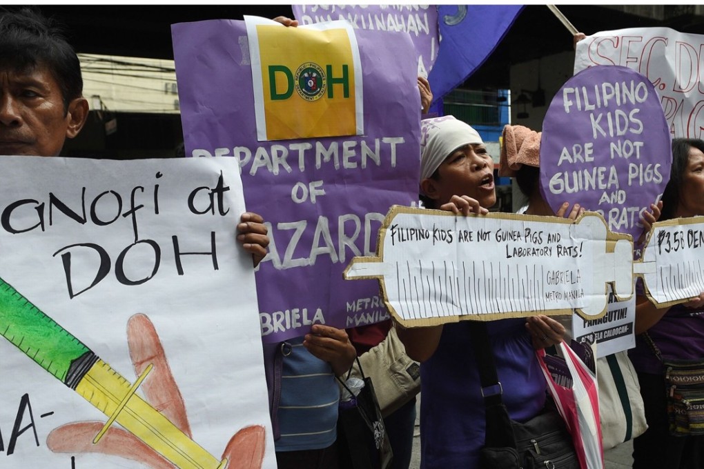 Demonstrators hold up posters and shout slogans during a rally in front of the Department of Health office in Manila, following the suspension of the sale and distribution of Sanofi's dengue vaccine Dengvaxia. Photo: AFP
