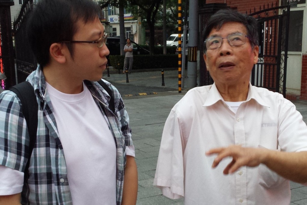 Simon Li, director of education at the Hong Kong Holocaust and Tolerance Centre, in Beijing with Gao Xiongfei, who was only four years old when he lost his arm after Japanese Imperial Army bombed his hometown of Yongan.