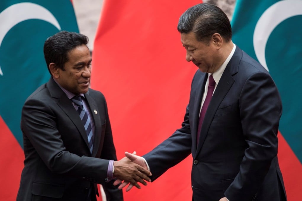 Abdulla Yameen Abdul Gayoom (left) shakes hands with Xi Jinping after signing deals at the Great Hall of the People in Beijing on Thursday. Photo: Reuters