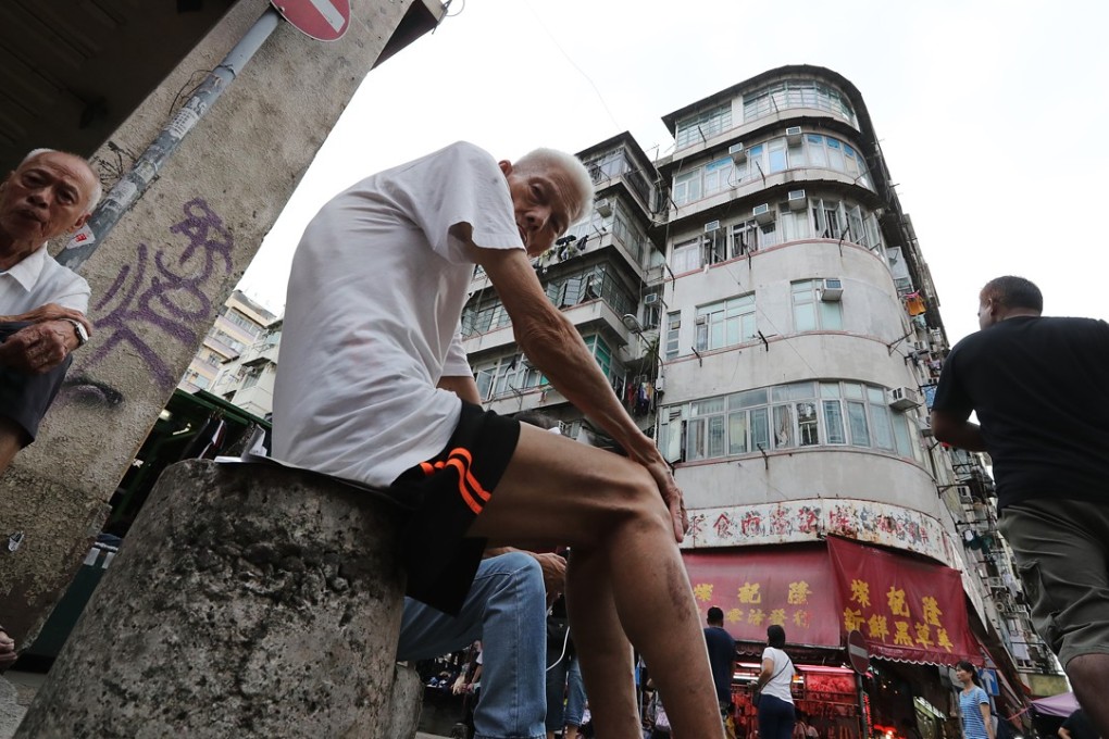 Elderly residents sit on a street in Sham Shui Po. Photo: Edward Wong