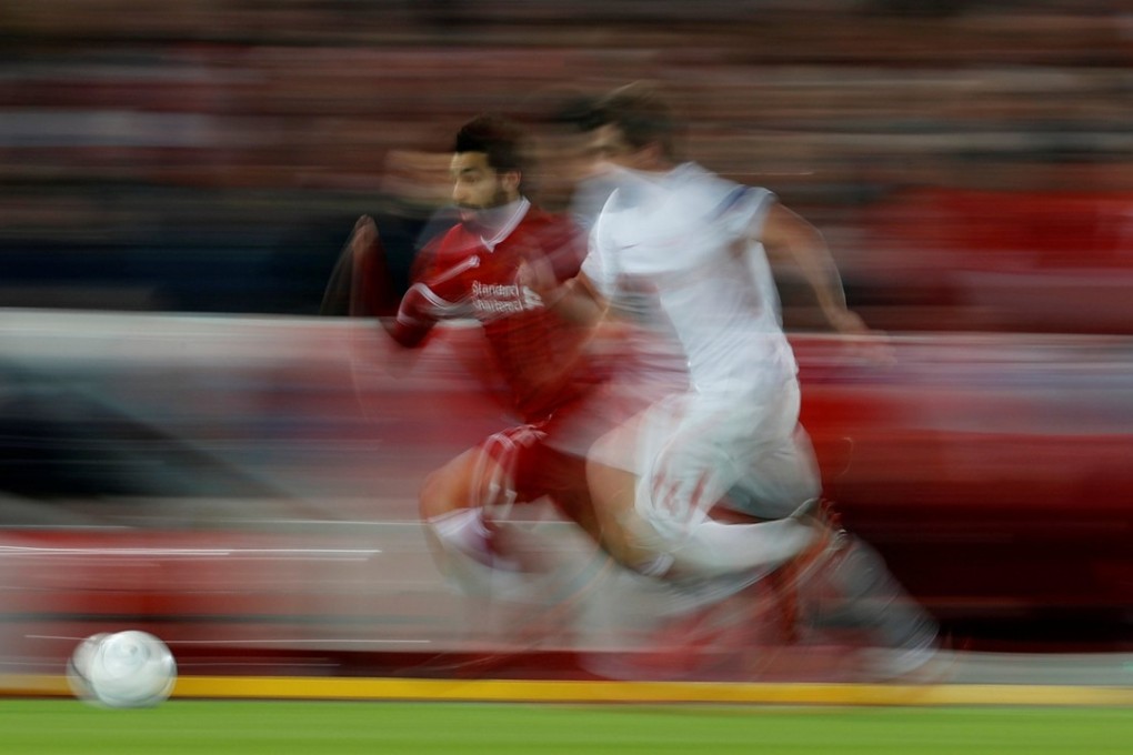 Liverpool’s Mohamed Salah storms past Spartak Moscow’s Georgi Dzhikiya during the 7-0 trouncing. Photo: Reuters