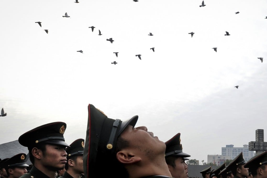 Pigeons are released to symbolise the victims of the 1937 Nanking massacre. Photo: AP