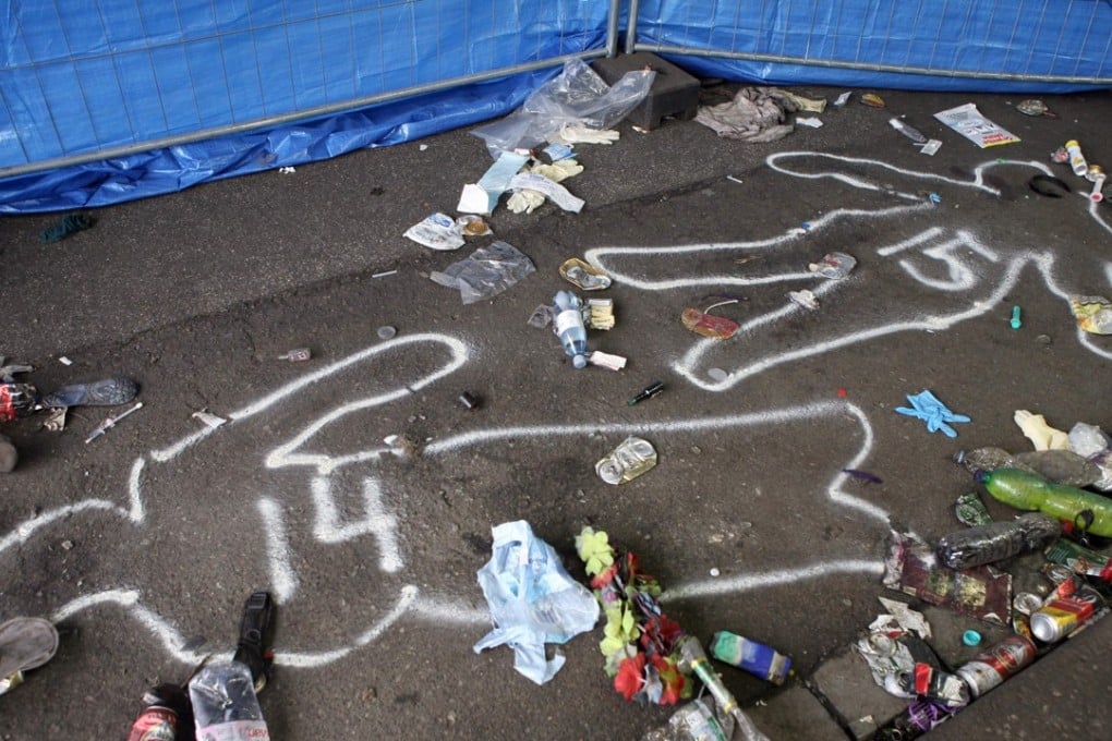 Outlines of bodies drawn on the pavement at the entrance to the tunnel where panic broke out during the Love Parade music festival in Duisburg, western Germany. Photo: AFP