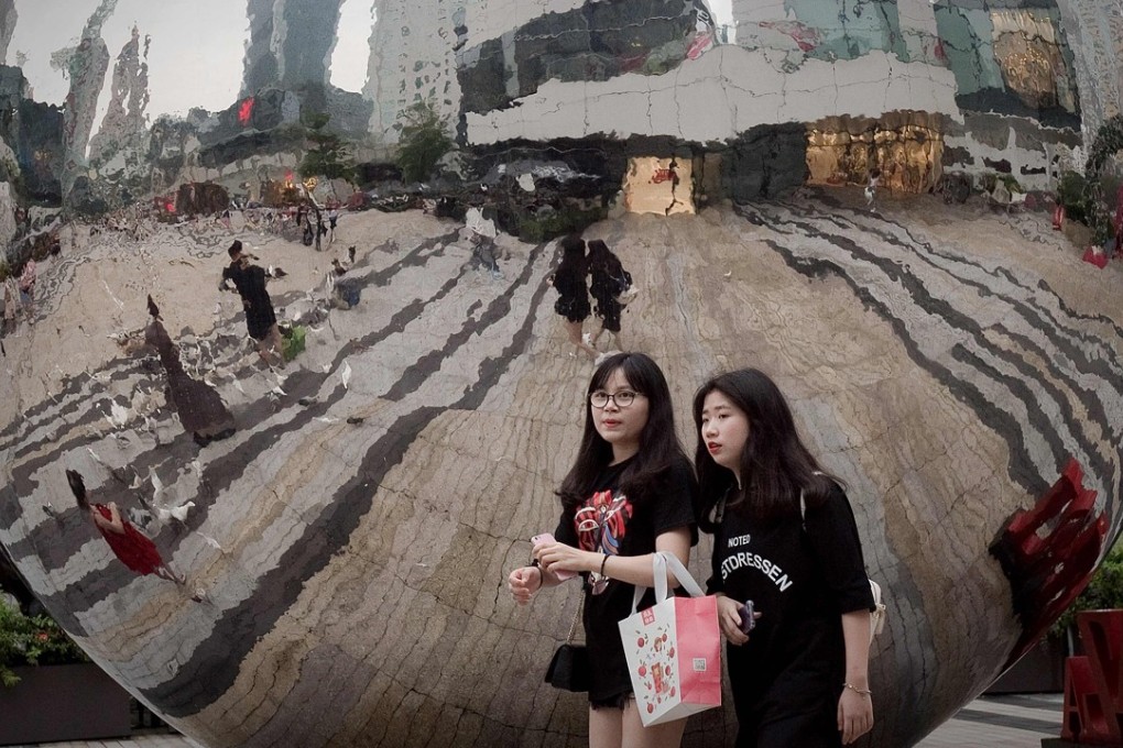 Pedestrians walk in a mall in Shenzhen. Growing consumption remains paramount to China’s future economy. Photo: AFP