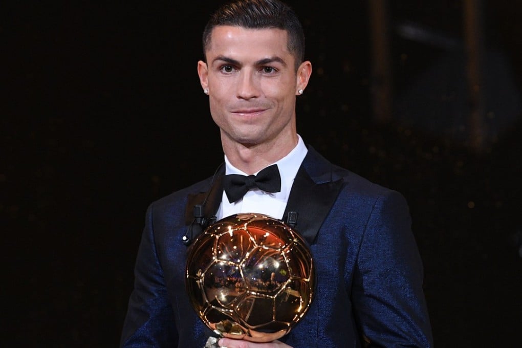 This handout photo released on December 7, 2017 by L'Equipe shows Portuguese player Cristiano Ronaldo posing with the 2017 Ballon d'Or France Football trophy in Paris. Portuguese star Cristiano Ronaldo won a record-equalling fifth Ballon d'Or. Photo: AFP