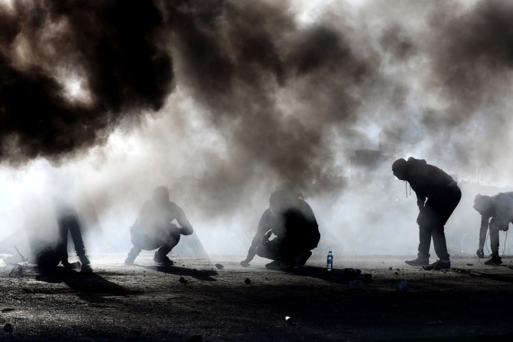 Palestinian protestors hurl stones at Israeli troops during clashes in the West Bank city of Ramallah on Friday. Photo: EPA