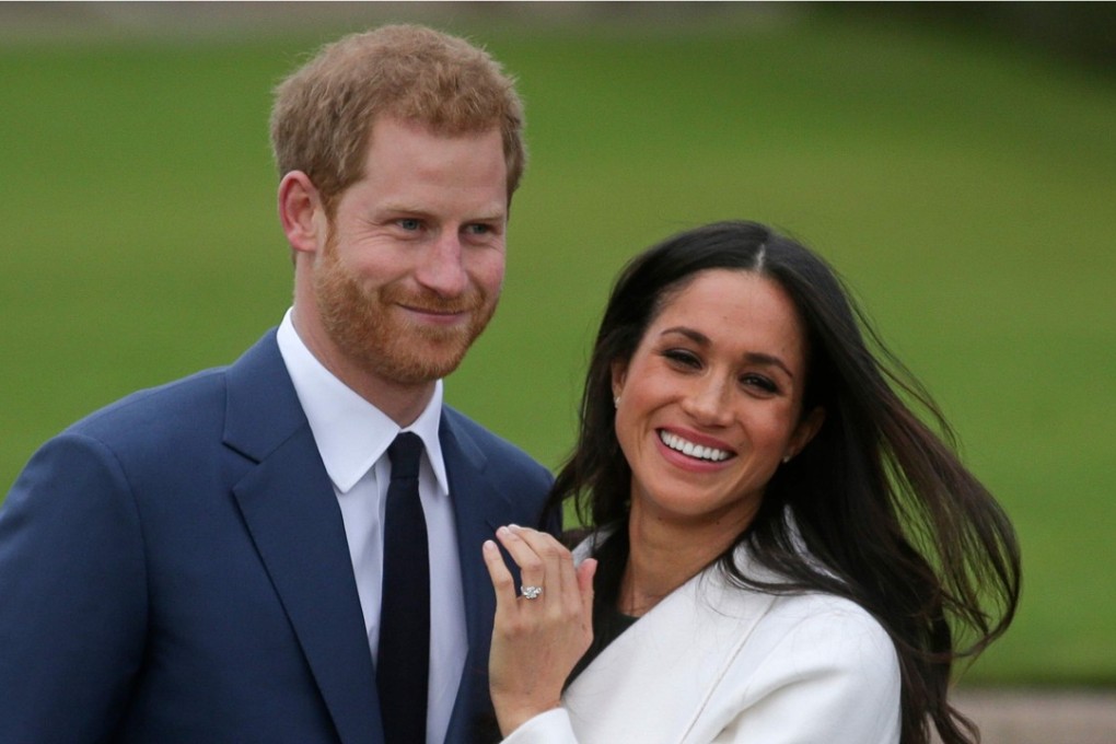 Britain’s Prince Harry stands with his fiancée, US actress Meghan Markle, as she shows off her engagement ring following the announcement of their betrothal on November 27. The couple are expected to get married in May next year. Photo: AFP