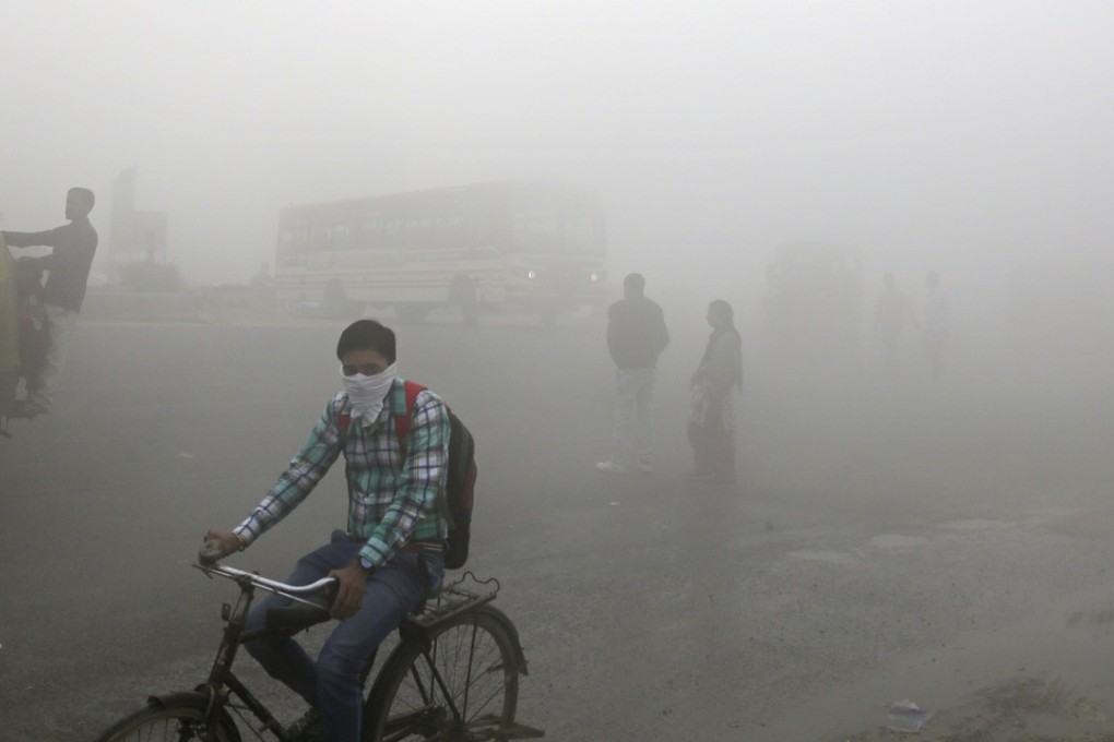 Indian commuters are hit by a thick blanket of smog on the outskirts of New Delhi. The country’s reliance on dirty energy, such as coal, is fuelling the pollution crisis. Photo: AP