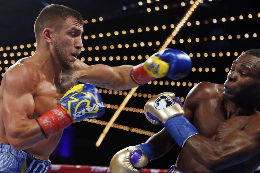 Vasyl Lomachenko throws a left at Guillermo Rigondeaux during the third round of their WBO junior lightweight title fight. Photo: AP