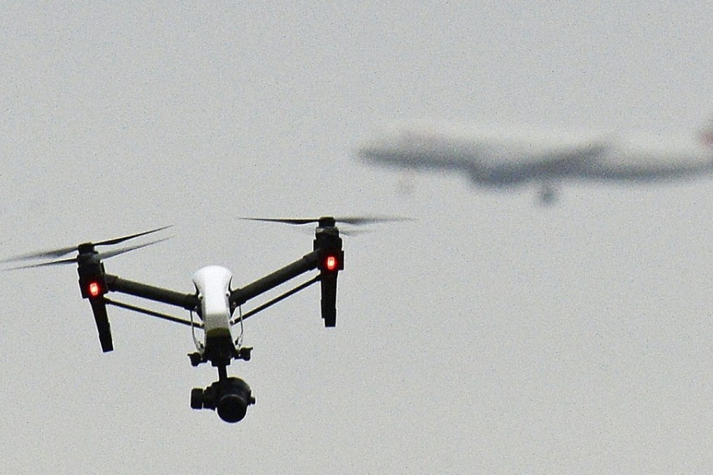 A drone flying west of London, England, as a British Airways plane prepares to land at Heathrow Airport. Photo: AP