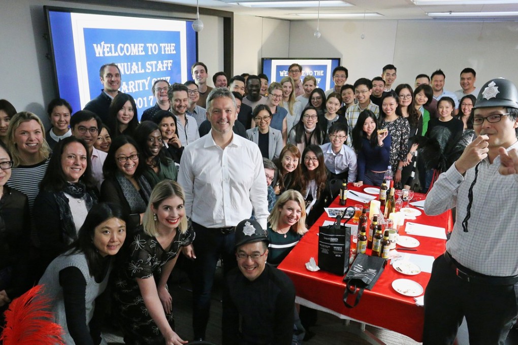 Law firm Clifford Chance held its annual staff quiz to raise funds for Operation Santa Claus, with its regional managing partner Geraint Hughes (centre) as quizmaster. Photo: Dickson Lee