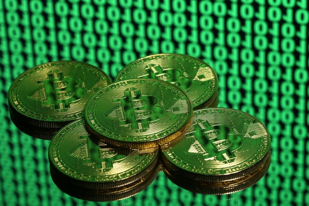 Tokens of the cryptocurrency bitcoin placed on a monitor displaying binary digits. Even if regulatory changes in the US do deflate the bitcoin bubble, they will not halt this financial revolution. Photo: Reuters