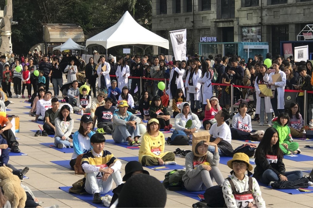 Contestants do their best at doing nothing in Songshan Cultural Creative Park in central Taipei on Sunday. Photo: Louise Watt