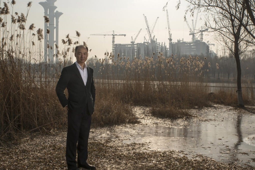Ma Jun, the founder of the Institute of Public & Environmental Affairs, poses for a photograph in a park in Beijing. The institute collects pollution data from government websites and publishes it on the Blue Map app. Photo: Bloomberg