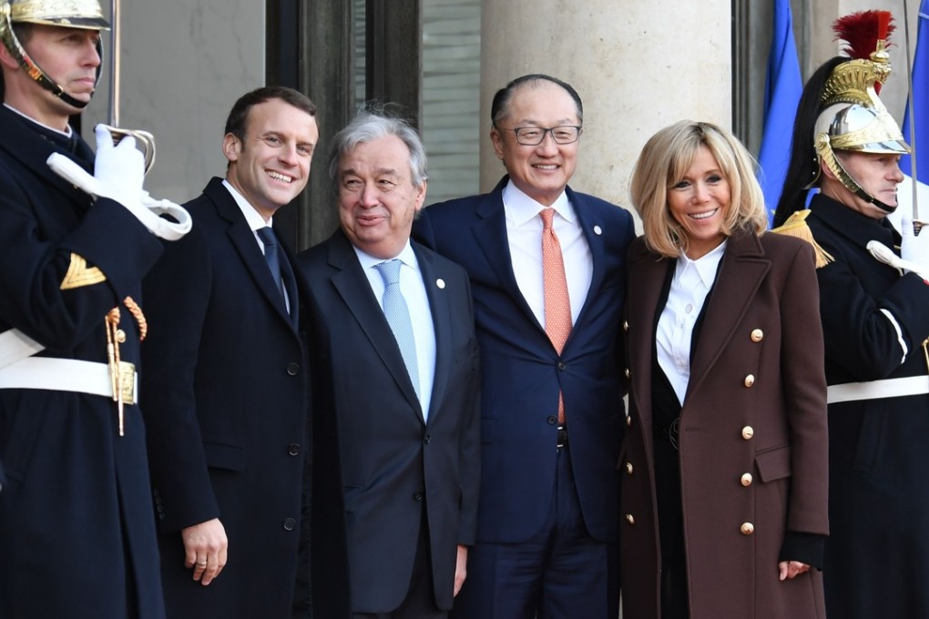 French President Emmanuel Macron with his wife Brigitte Macron and United Nations Secretary General Antonio Guterres and World Bank President Jim Yong Kim. Photo: AFP