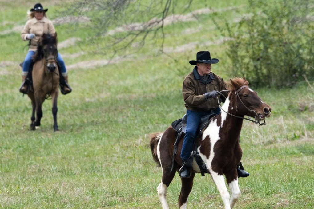 Republican senate candidate Roy Moore and his wife Kayla Moore ride horses to a polling station to cast their votes in Alabama's special Senate election in Gallant, Alabama, on Tuesday. Photo: AP