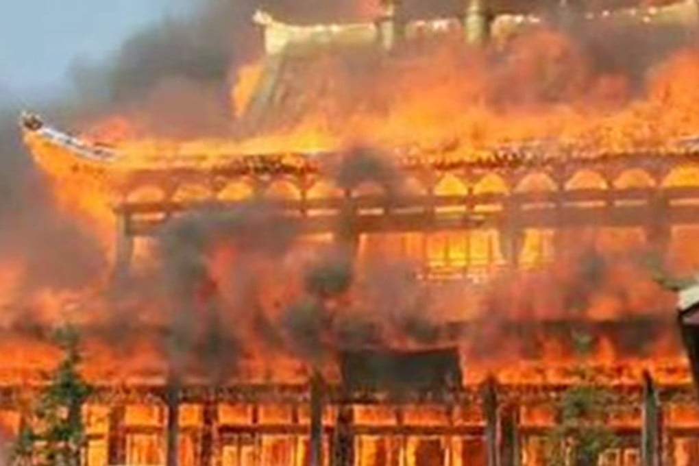 A wooden pagoda and a prayer hall were razed to the ground when a fire broke out at a Buddhist temple in southwestern China on Sunday. Photo: Handout