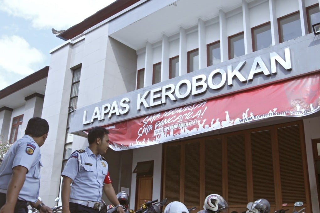 Prison officials walk in front of the main entrance to the Kerobokan prison in Denpasar, Bali. Photo: AP