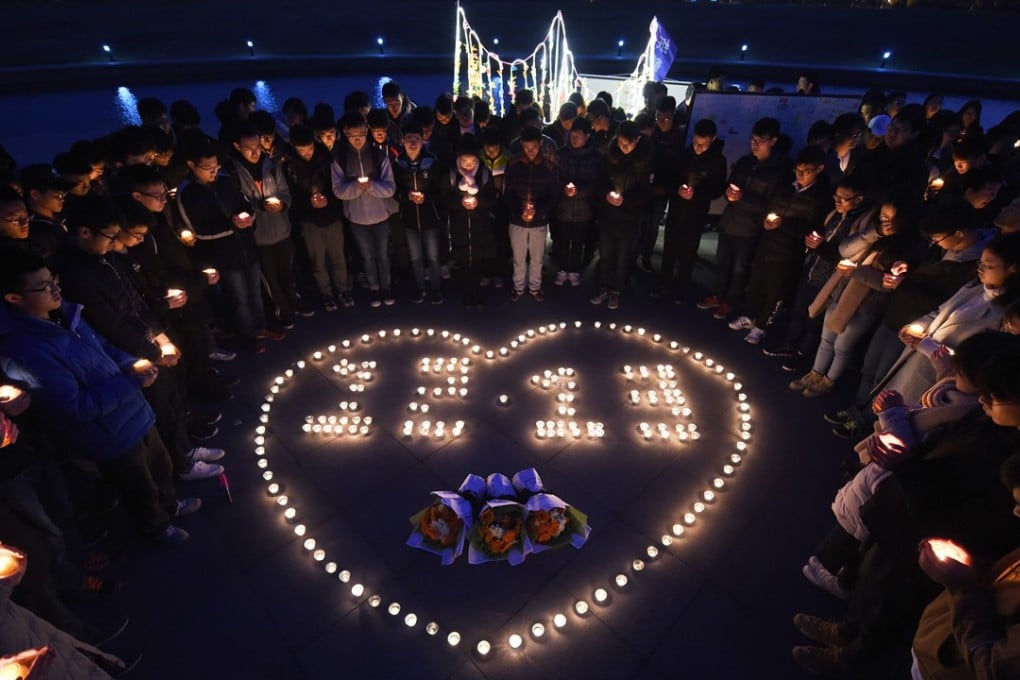 Students at Southeast University in Nanjing held a candlelit vigil on Tuesday to commemorate the anniversary of the Nanking massacre. Photo: Xinhua