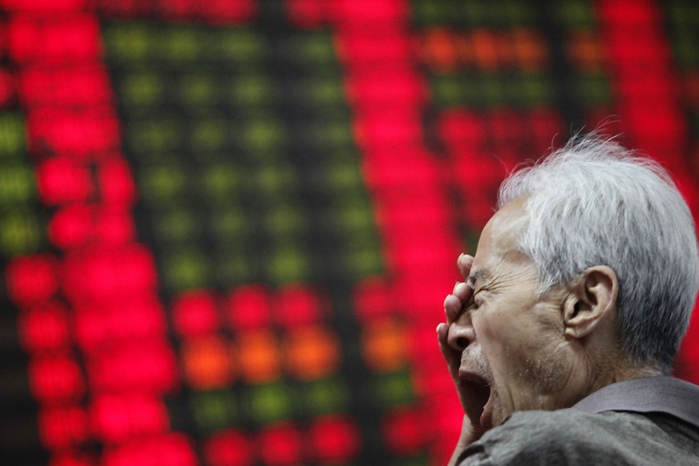 An investor yawns as he looks at a stock price monitor at a private securities company in Shanghai.Photo: AP