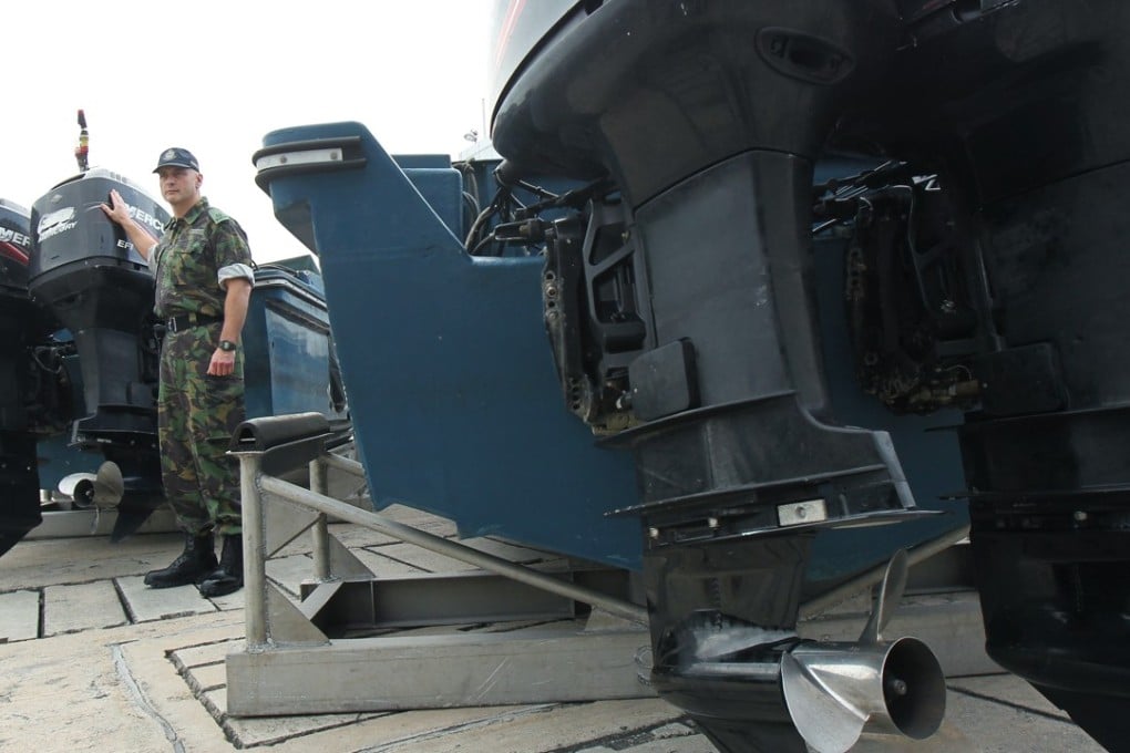 Hong Kong police superintendent John Cameron with the seized speedboats at Stonecutters Island. Photo: Oliver Tsang