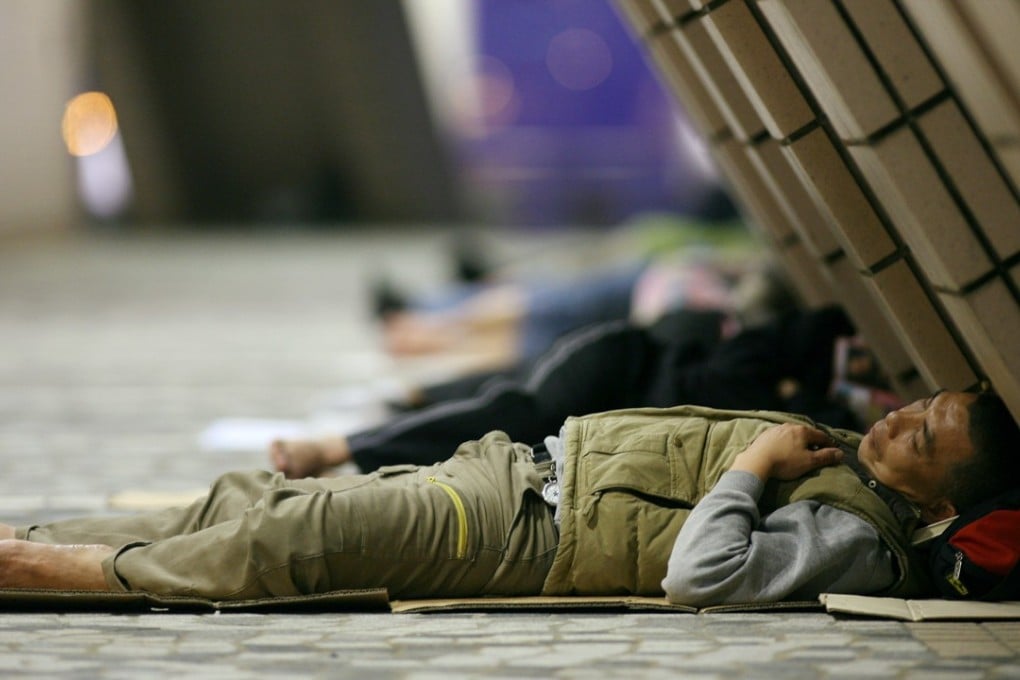 Street sleepers outside the Hong Kong Cultural Centre in Tsim Sha Tsui. A sensible definition of poverty should define the basic needs of the people, such as food, clothing and housing. Photo: Dickson Lee