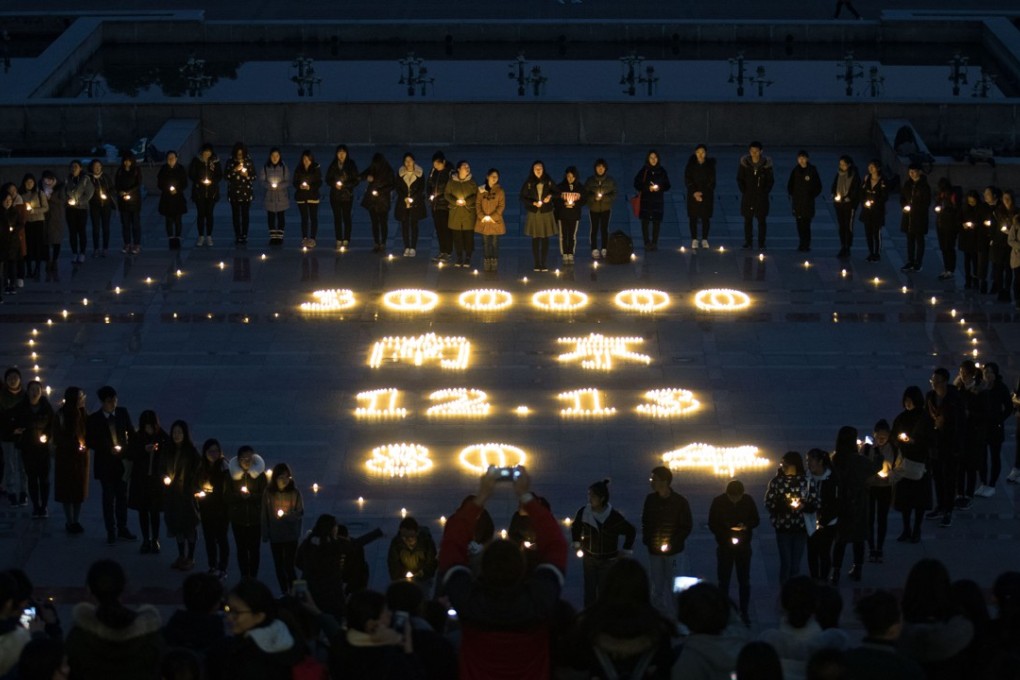 Students light candles at Nanjing Normal University on December 11, 2017 during a memorial ceremony ahead of China's National Memorial Day for Nanjing massacre victims in Nanjing city, east China's Jiangsu province. Photo: AFP