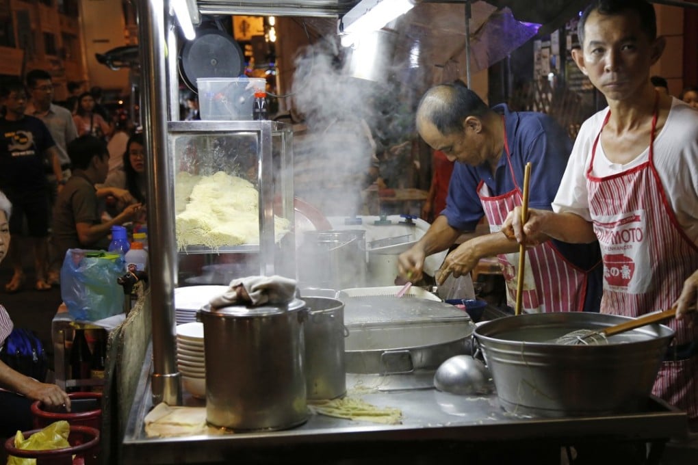 A cook prepares a noodle dish from a street food stall along Lebuh Chulia, a popular nightlife strip, in George Town on the island of Penang, Malaysia. Photo: AP Photo/Adam Schreck