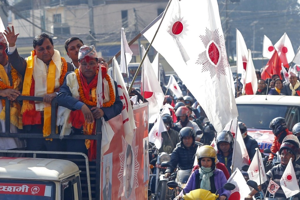 Ishwor Pokhrel (second left), general secretary of Communist Party of Nepal-Union Marxist and Leninist, takes par in an election victory rally in Kathmandu on Tuesday. Photo: EPA