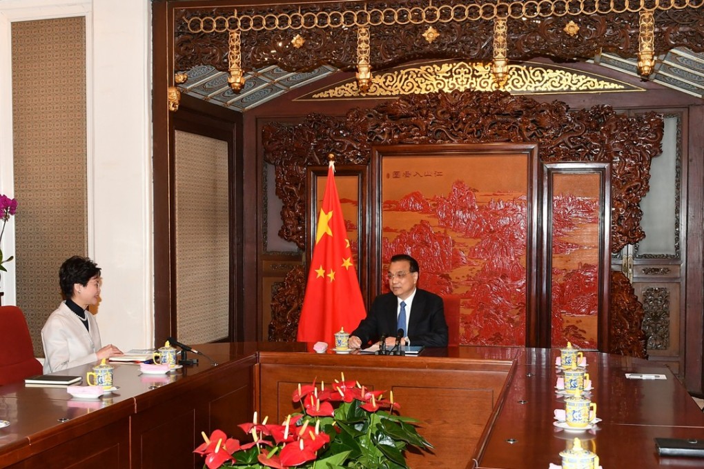 Hong Kong Chief Executive Carrie Lam briefs Premier Li Keqiang (centre) in Beijing. Photo: Handout