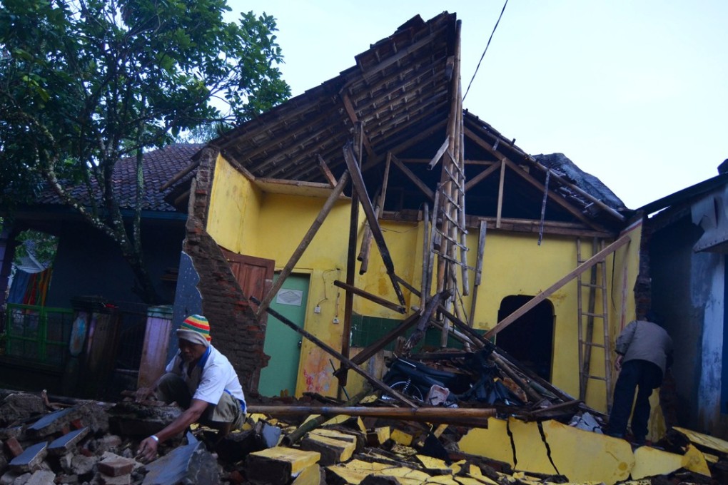 A man cleans up the wreckage after a house was damaged by the earthquake in Sumelap Village, Tasikmalaya City, West Java. Photo: Reuters