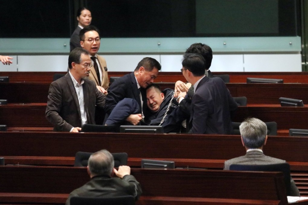 Ray Chan Chi-chuen being removed from the Legco Chamber. Photo: Felix Wong
