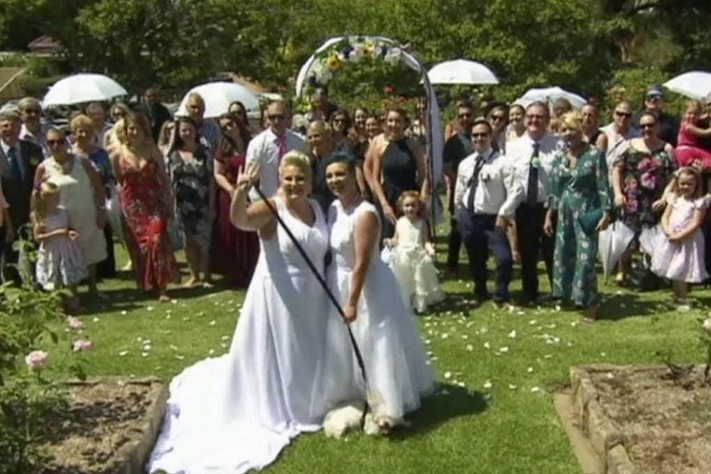 Amy Laker and Lauren Price pose for a photo during their ceremony in Sydney. Photo: AP