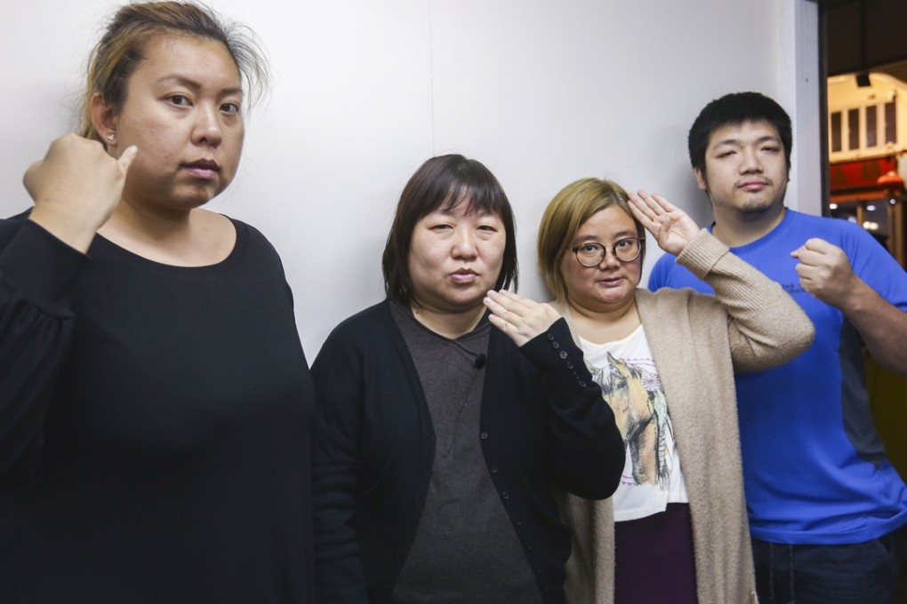 From left: Christine Chu Chi-yan, Joyce Pun Chung-see, Connie Lo Chun-you and Kane Cheung Chung-kit make a sign which means ‘deaf people’s right to call the police’. Photo: Xiaomei Chen