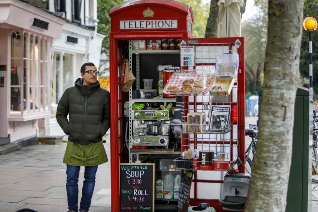 Umar Khalid stands outside the converted red telephone box from where he runs a coffee shop in Hampstead Heath, north London. Photo: AFP