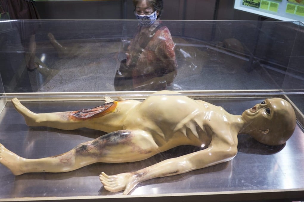 A woman looks at the model of an alien from the debunked 1995 “Alien Autopsy” video, at an exhibition in Beijing in 2012. Photo: EPA