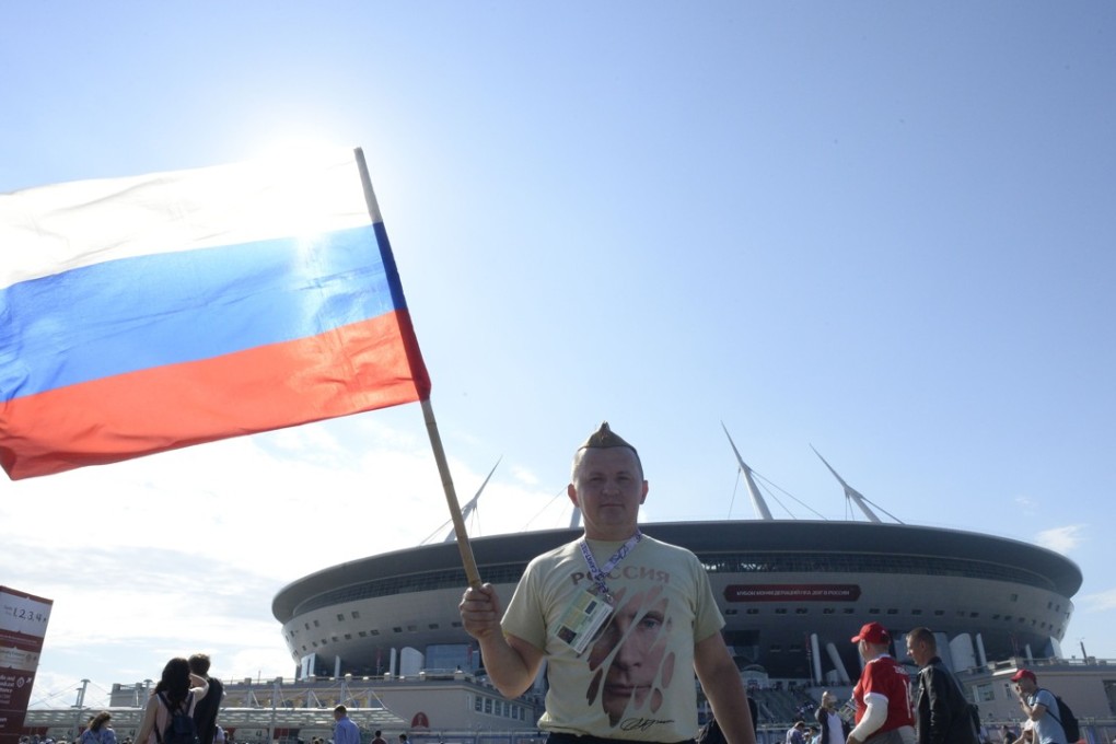 A Russian fan holds up the national flag as he arrives for the 2017 Confederations Cup match between Russia and New Zealand at the Saint Petersburg Stadium. Photo: AFP