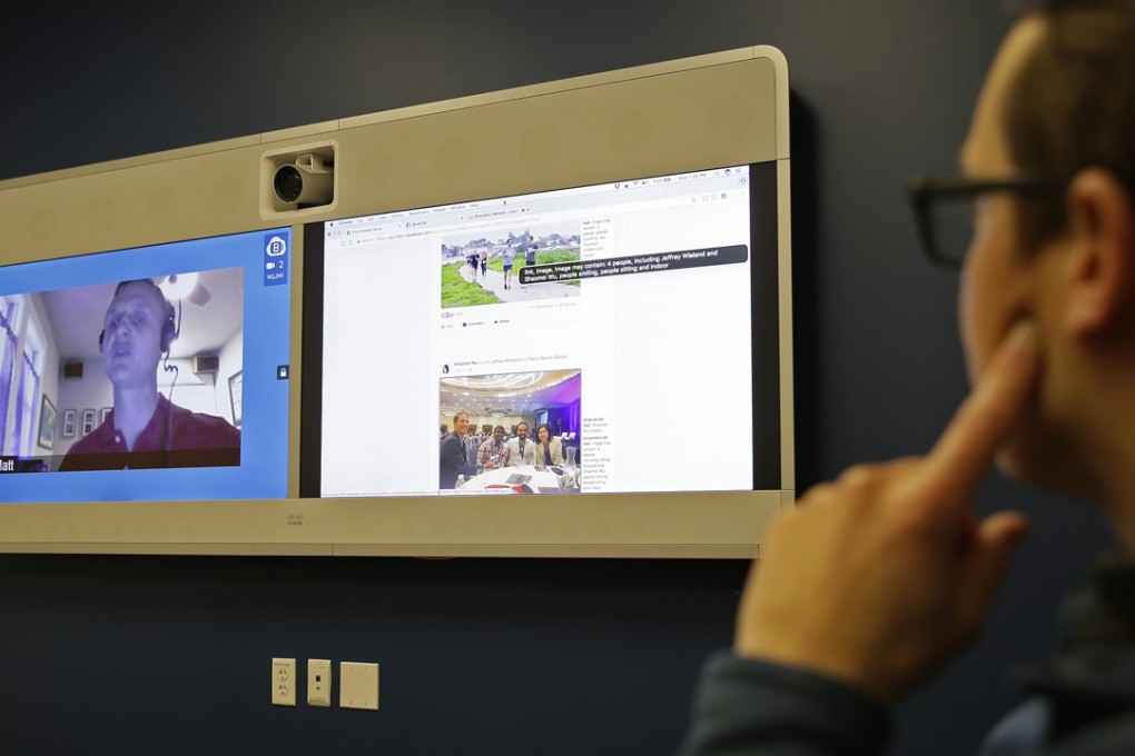 In this photo taken on December 18, 2017, Jeff Wieland, (right), Facebook director of accessibility, watches as engineer Matt King, who is blind, demonstrates facial recognition technology via a teleconference at Facebook headquarters in Menlo Park, California. Photo: AP