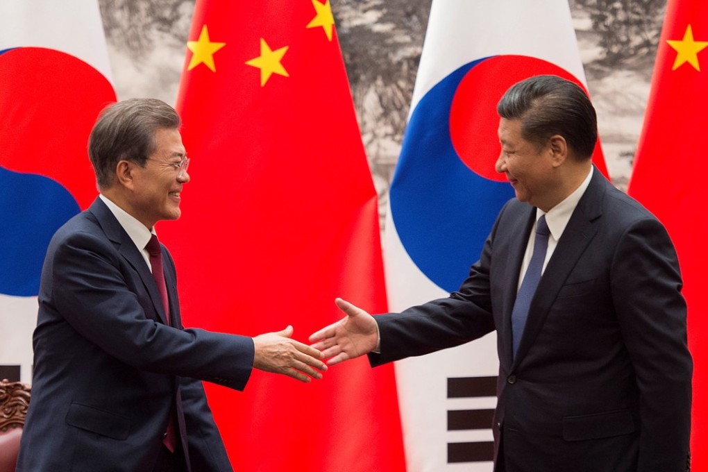 South Korean President Moon Jae-In and Chinese President Xi Jinping shake hands after a signing ceremony at the Great Hall of the People in Beijing, China on December 14, 2017. Photo: Reuters