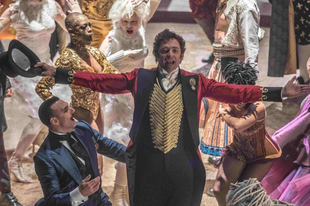 Hugh Jackman (centre) as P.T. Barnum in The Greatest Showman (category: IIA). The film, which co-stars Michelle Williams, Zac Efron, and Rebecca Ferguson, is directed by Michael Gracey.