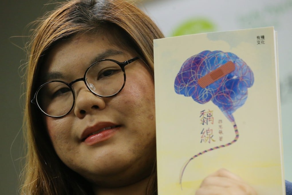 Sushi Siu, a patient who is recovering from psychosis, holds up her book in which she shares her experience with the illness. Photo: Dickson Lee