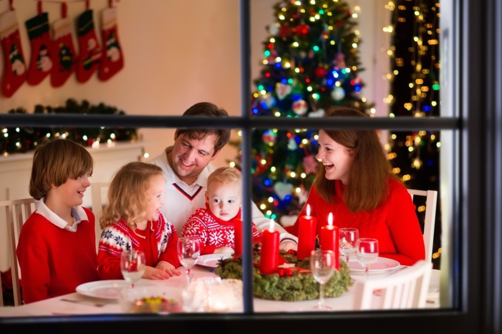 Stock photo of a family with three children celebrating Christmas at home. Photo: Alamy