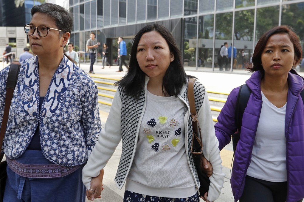 Former domestic helper Erwiana Sulistyaningsih (centre) successfully won her claim against her abusive former employer. Photo: Edward Wong