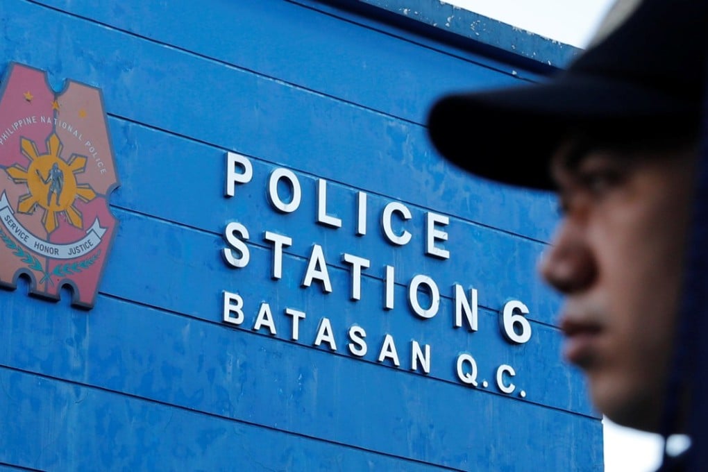 A policeman waits for the start of a flag-raising ceremony at the grounds of Station 6, Batasan Police Station, in Quezon City, Metro Manila. Photo: Reuters