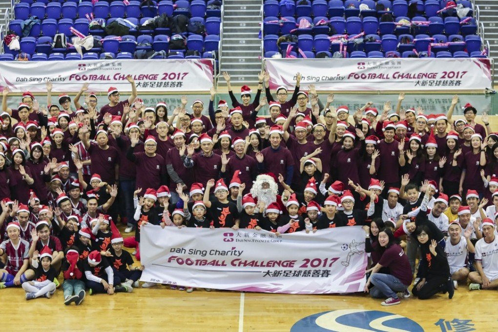 Around 150 volunteers from Dah Sing Bank joined 30 kids for a football challenge to raise funds for Operation Santa Claus. Photo: Jonathan Wong