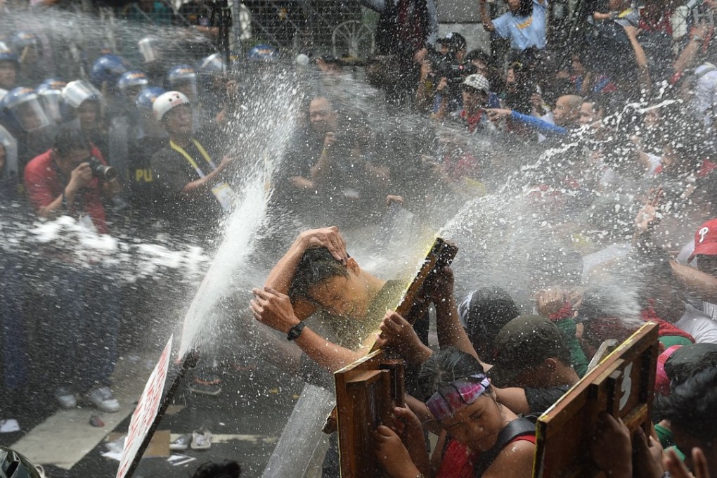 Riot policemen and protesters clash as they try to march to the Asean Summit venue in Manila. Photo: AFP