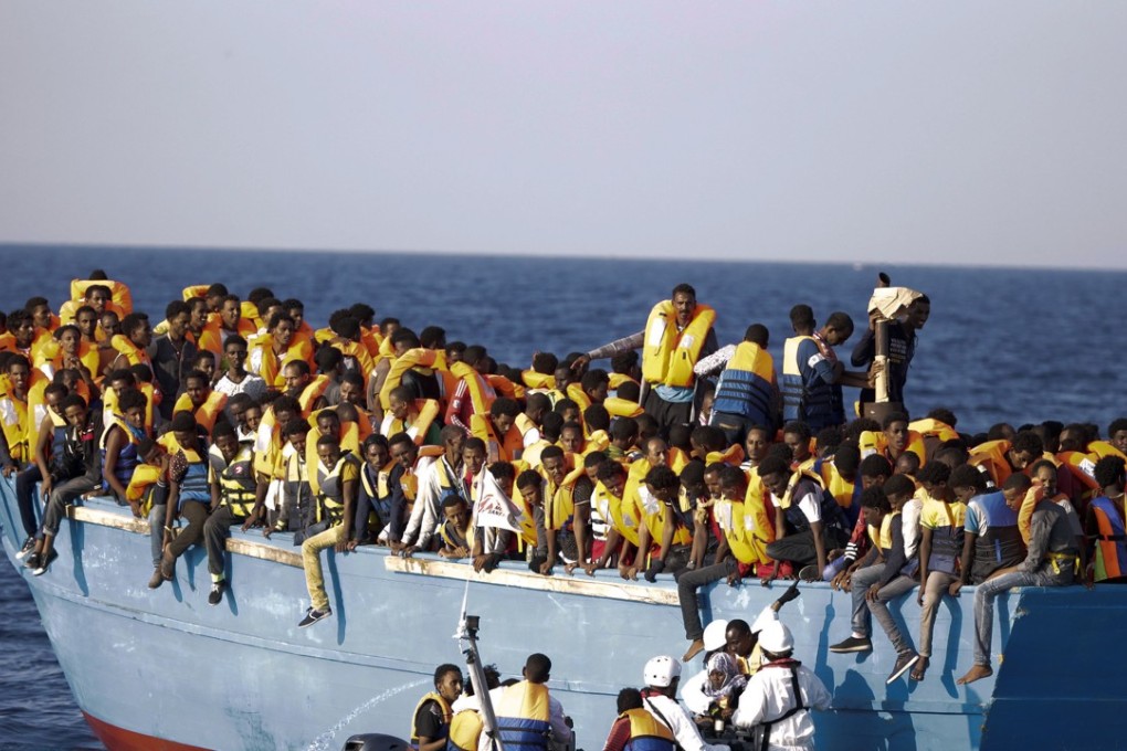 A crowded wooden boat carrying more than seven hundred migrants, during a rescue operation in the Mediterranean Sea, about 13 miles north of Sabratha, Libya. Scientists say climate change could dramatically increase the number of people seeking asylum in Europe. Photo: AP